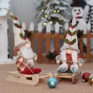 Christmas gnome couple sitting on wooden sleds for festive holiday home decorations