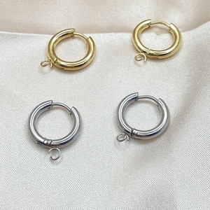 DIY stainless steel hoop earrings in gold and silver finish on soft silk fabric