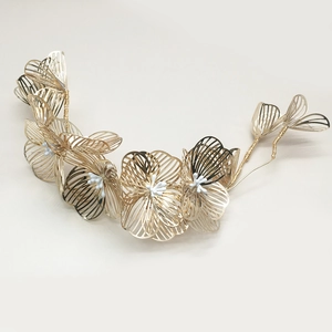 Detail of bridal gold flower headband with handcrafted wire petals and white pearls