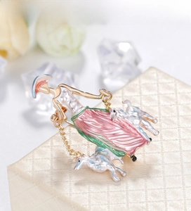 Detailed view of elegant enamel lady brooch with two dogs on a beige jewelry display box
