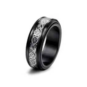 Macro detail of men's black titanium band with silver Celtic dragon inlay and rotatable design