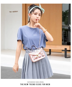 Detail of pink daisy floral transparent PVC shoulder bag with golden heart lock and flap