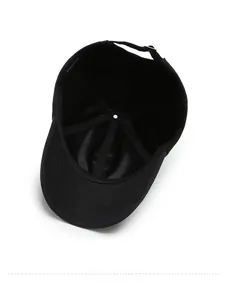 Detail shot of the 100% cotton inner lining and material label of the black baseball cap
