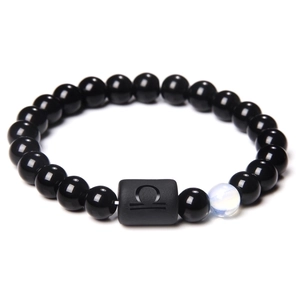 Detail view of black beaded bracelet featuring Libra zodiac symbol on a matte rectangular bead