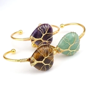 Detail of handmade gold wire heart-shaped crystal bangles with Tree of Life design