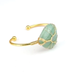 Handmade gold wire-wrapped open cuff bracelet with green crystal tree of life design