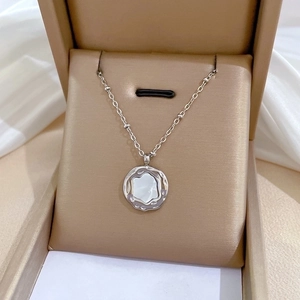 Detailed view of an irregular shell pendant necklace in a premium jewelry gift box