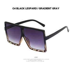 Detail of square oversized sunglasses in black leopard frame with gradient gray lenses
