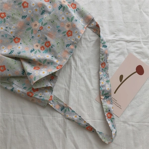 Detailed macro view of floral cotton canvas tote with daisy prints and long shoulder strap