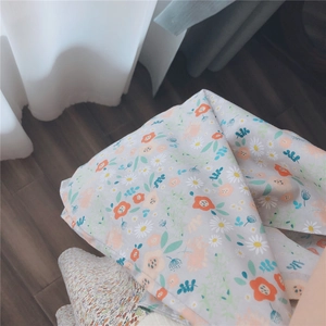 Detailed view of floral cotton fabric with daisy pattern and soft natural texture
