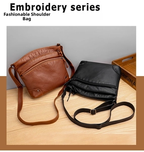Detail view of soft leather shoulder bags with multi-pocket design and metal rivets