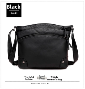 Front view of black soft leather crossbody bag featuring silver studs and zipper compartments