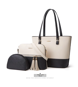Detailed shot of black and white Saffiano leather tote bag 3-piece set with gold hardware