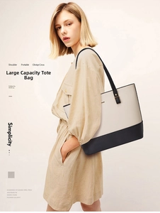 Fashion model wearing a large black and white contrast tote bag with thin straps