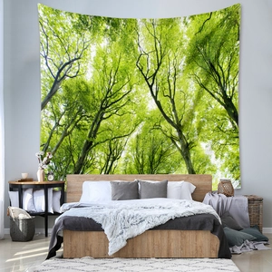 Detail of bohemian forest tapestry showing lush green trees and natural sunlight on wall