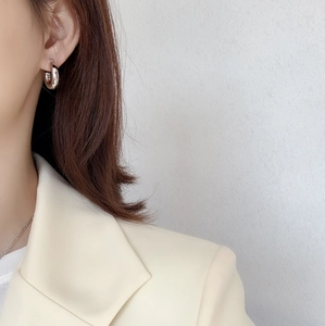Close-up of minimalist S925 sterling silver C-shaped hoop earrings on female model