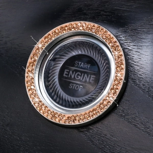 Macro shot of sparkling champagne crystal rhinestones on a car engine start button ring