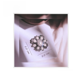 Detailed view of vintage baroque silver flower brooch with opal stones, 5.0 cm x 5.0 cm