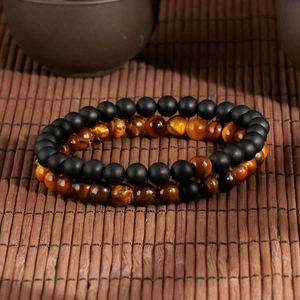 Retro tiger eye stone and matte onyx beaded bracelets on a natural bamboo mat
