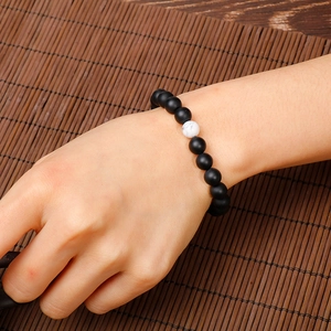Minimalist beaded bracelet with matte black beads and white marble turquoise accent