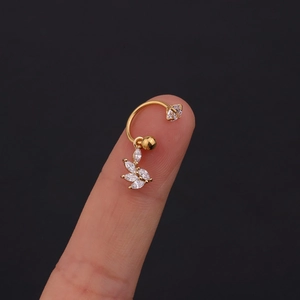 Detailed macro view of gold-plated curved barbell with leaf-shaped zirconia crystals