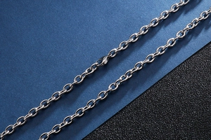 Detail of silver stainless steel cross chain with secure lobster clasp for men