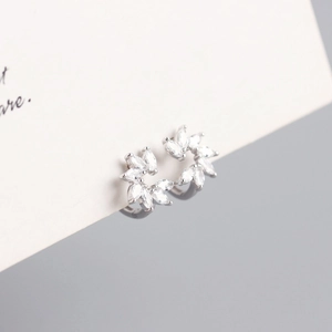 Macro shot of silver marquise zircon flower hoop earrings with high-quality metal texture