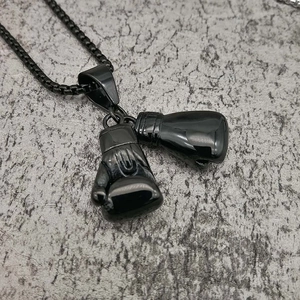 Black stainless steel boxing glove pendant necklace for hip hop style on stone surface