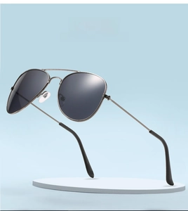Detail view of aviator kids sunglasses with gunmetal frame on a white display stand