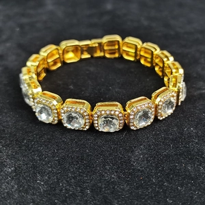 Macro shot of hip hop style gold chain links set with square transparent stones