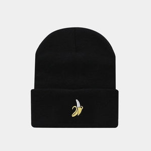 Close-up of a black knitted beanie featuring detailed yellow banana embroidery on the cuff