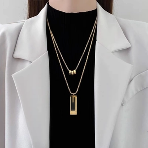 Double-layered gold titanium steel necklace with geometric cylinder and rectangular pendants