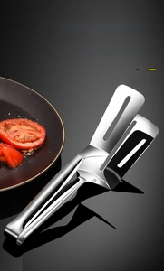 Close-up of stainless steel food tongs with hollowed-out spatula head for frying fish