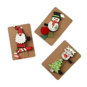 Three pairs of Christmas glitter hair clips featuring Santa, Snowman, and Reindeer designs