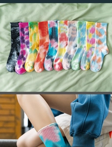 Close-up of assorted tie-dye cotton mid-calf socks showing ribbed cuffs and vibrant gradients