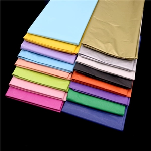 Close-up of vibrant multicolored tissue paper sheets neatly stacked for gift wrapping