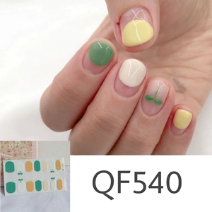 Detailed close-up of matte daisy nail stickers QF540 with green heart patterns and flowers