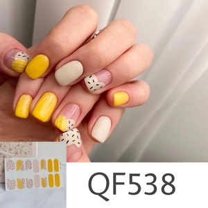 Detail of QF538 matte daisy nail wraps with yellow polka dots and abstract stripe patterns