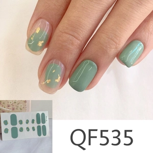 Detail of green matte nail stickers with gold foil accents and QF535 sheet