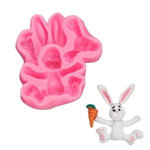 Detail of pink silicone rabbit mold with white finished product for fondant baking