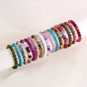 Detailed display of colorful natural stone beaded bracelets on white display rolls