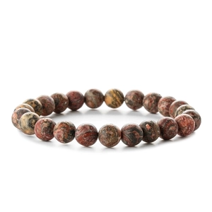 Detail of natural zebra stone beaded bracelet with reddish-brown and black mineral textures
