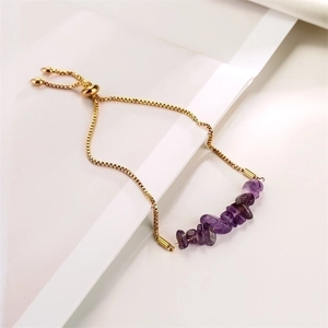 Detailed view of adjustable gold chain bracelet with irregular purple crystal stones