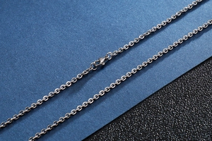 Detailed macro view of silver stainless steel chain link and secure lobster clasp closure