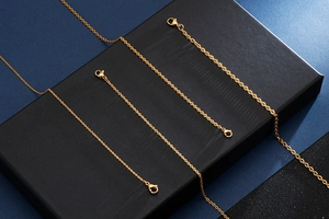 Detail view of gold stainless steel extension chains with secure lobster clasps