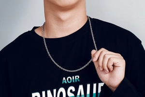 Silver stainless steel cross chain necklace shown on a model wearing a black t-shirt