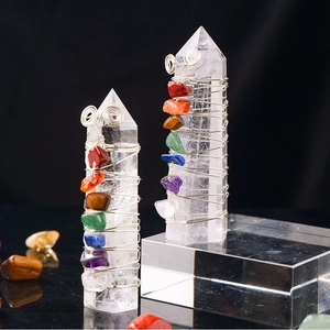 Detailed view of silver wire wrapped natural crystal pillars with colorful chakra stones