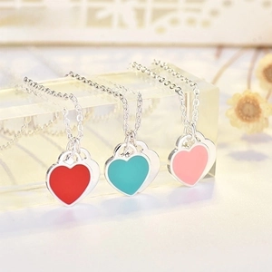 Detail view of double heart enamel pendants in red, blue and pink with silver chain
