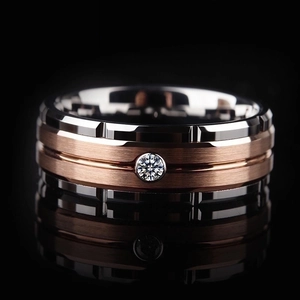 Macro shot of silver and rose gold ring with brushed metal texture and zircon