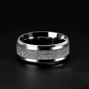 Macro shot of silver titanium steel ring featuring an intricate rime texture inlay